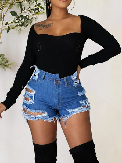 Trendsi model wearing Women's distressed denim shorts. High waist frayed hem paired with black long sleeve bodysuit
