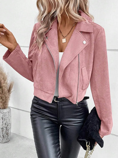 women's suede moto jacket in blush pink on model with white tank black faux leather pants gold pendant and black clutch