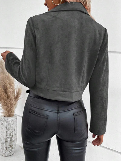 Back view of model wearing Trendsi women's suede moto jacket in charcoal with cropped hem paired with black faux leather pants