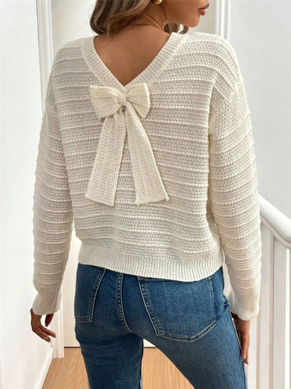 Trendsi Bow-Back Knit Top cream textured knit V back decorative bow shown paired with blue jeans