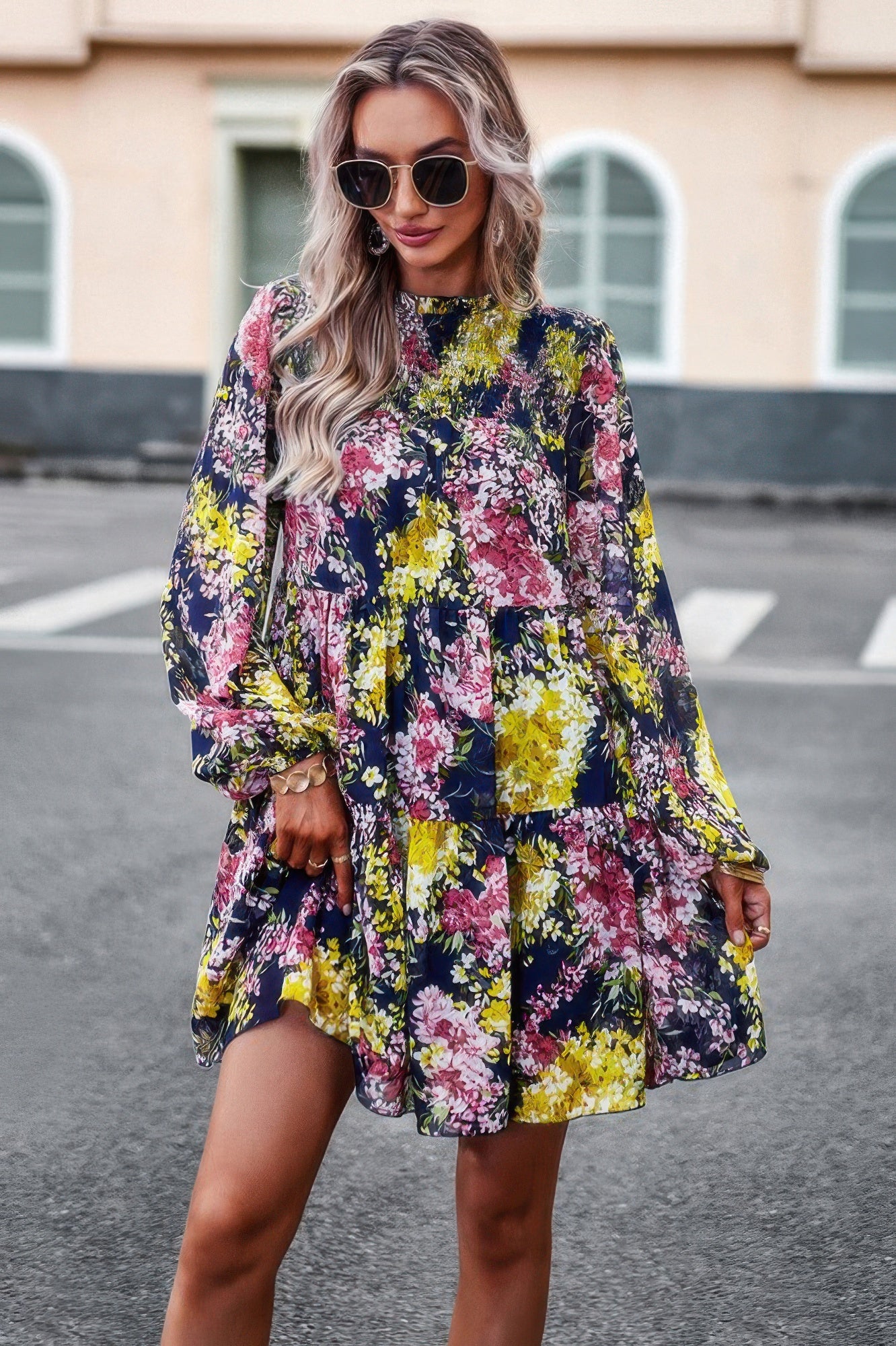 Model wearing CCWHOLESALECLOTHING floral print smock dress with long sleeves tiered skirt and sunglasses