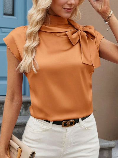 Trendsi women's bow tie blouse in caramel satin with cap sleeves and neck bow, tucked into white high waist jeans