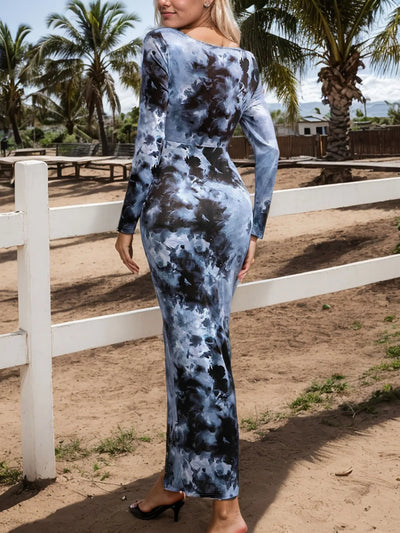 Model wearing Trendsi women's tie dye bodycon maxi dress back view long sleeve blue black print by white fence