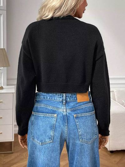 Trendsi Cropped Button-Up Cardigan in black with a relaxed fit and long sleeves, styled with high-waisted jeans