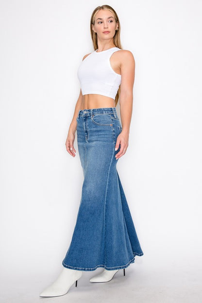 Artemis Vintage model wearing Mermaid Skirt with Gusset denim flared maxi paired with white crop tank and boots