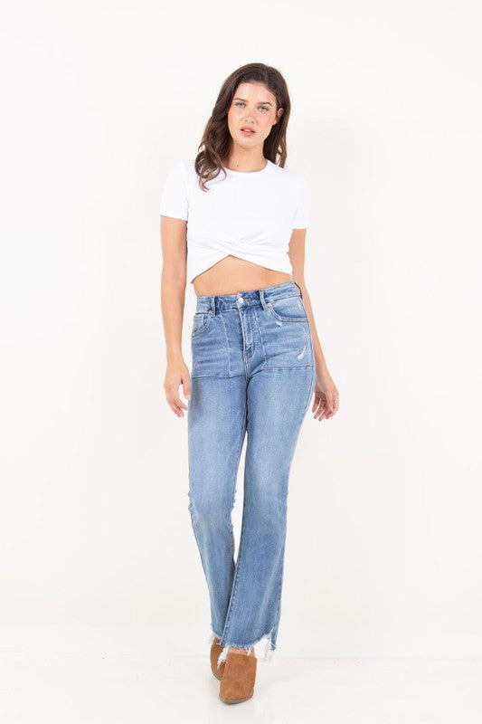 Artemis Vintage model wearing women's high rise tummy control jeans light wash straight leg with frayed hem