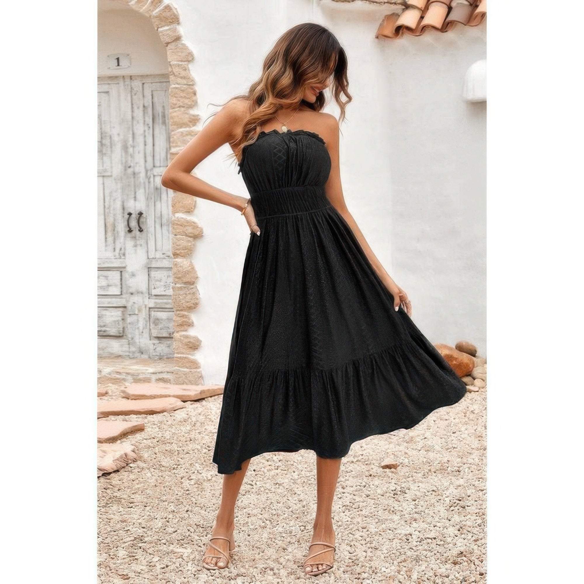 Model wearing black strapless Elasit Waist Ruffle Dress with smocked waist and tiered midi skirt for summer outings