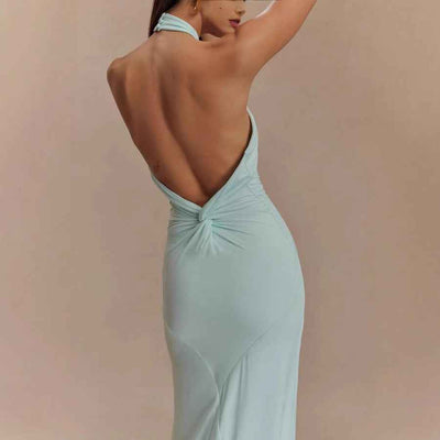 Back view of an elegant formal gown in light blue, showcasing a halter neck design and open back