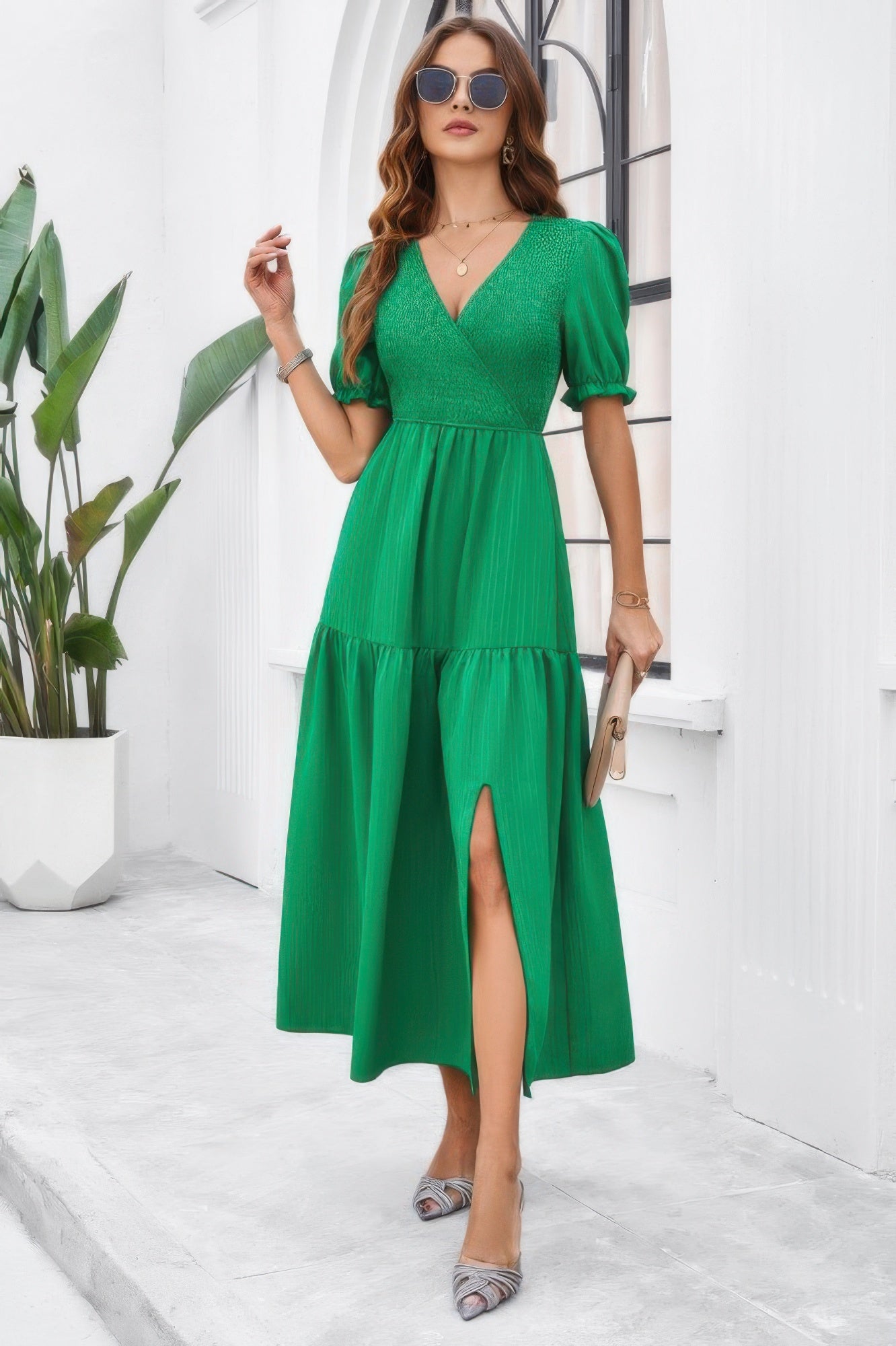 Model wearing a green High Waist Puff Sleeve Dress with V neck, smocked waist, front slit, and tiered midi skirt