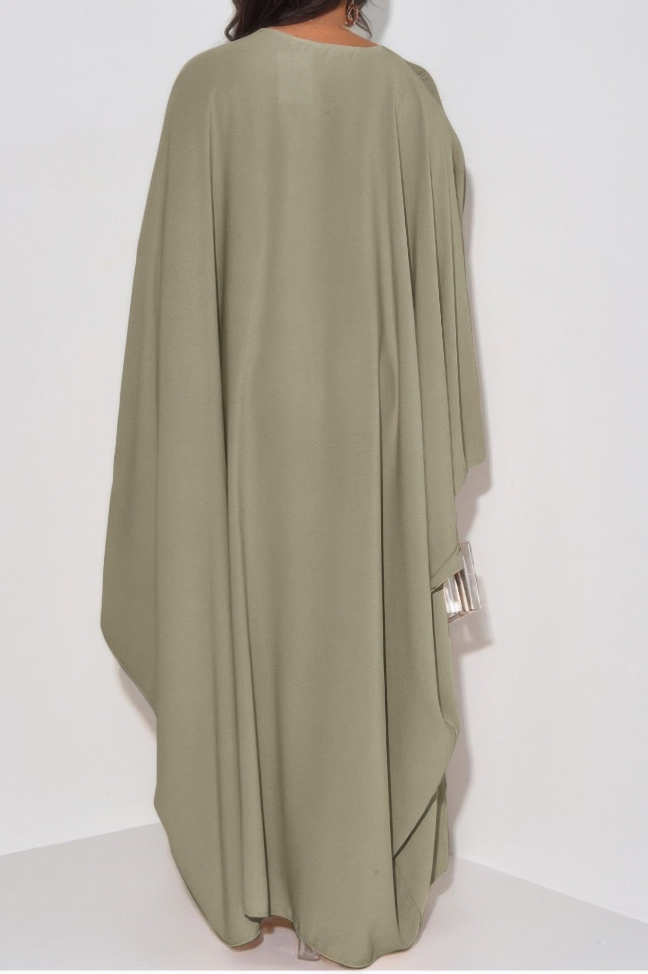 Back view of CCWHOLESALECLOTHING loose fit v neck maxi dress in sage green with draped cape sleeves