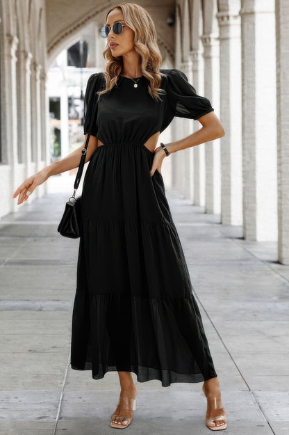 Woman modeling black Puff Sleeves Fit Dress with waist cutouts tiered skirt sunglasses and sandals