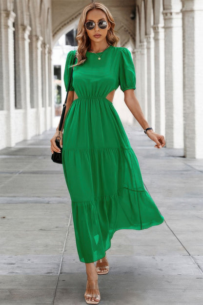 Woman in emerald green Puff Sleeves Fit Dress with cinched waist and tiered skirt sandals and sunglasses