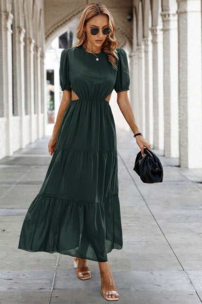 Model wearing dark green maxi Puff Sleeves Fit Dress with waist cutouts tiered skirt and black bag