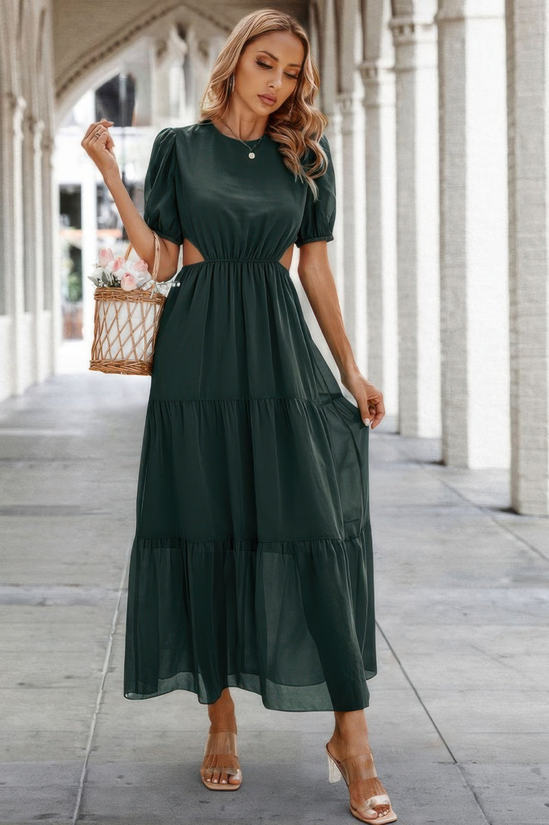 Model in dark green Puff Sleeves Fit Dress tiered maxi with side waist cutouts carrying wicker basket bag