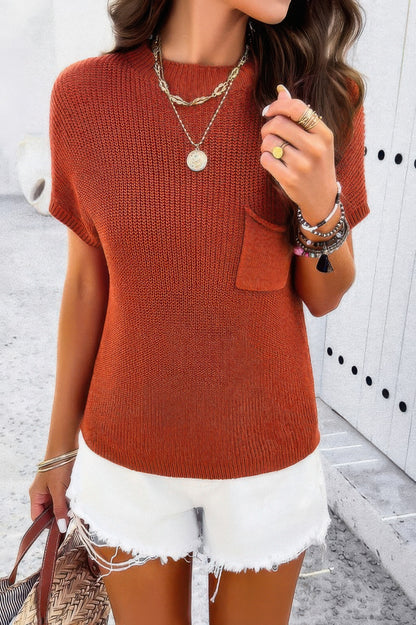 Woman wearing rust ribbed knit loose top with chest pocket white frayed denim shorts and layered jewelry