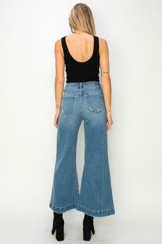 Artemis Vintage model back view wearing high waist wide leg flared Stretch Denim Jeans in medium blue