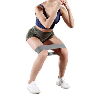 Fashions Envy Hip Booty Bands gray resistance band around thighs on woman squatting for glute workouts