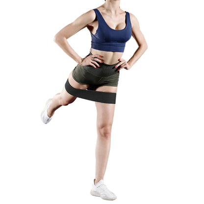 Fashions Envy Hip Booty Bands woman in blue sports bra and green shorts using black band for glute workout
