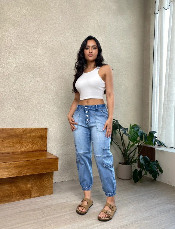 Trendsi model wearing Light Wash Joggers with button fly cargo pockets elastic cuffs and white crop tank