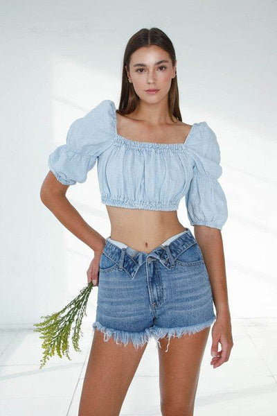 Stylish model wearing Front Ribbon Open Shorts paired with a cropped denim blouse and holding a bouquet