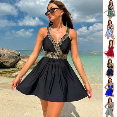 Trendsi black full coverage summer swimwear dress with gold trim worn on beach