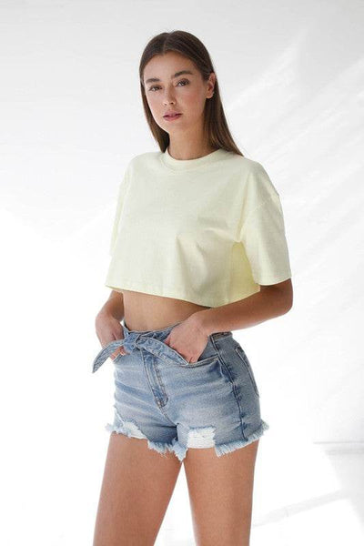 Model wearing High Waisted Denim Shorts with a cropped yellow t-shirt for a stylish summer outfit