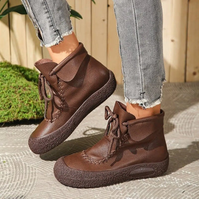 Trendsi brown lace-up casual ankle boots with textured soles paired with grey distressed jeans
