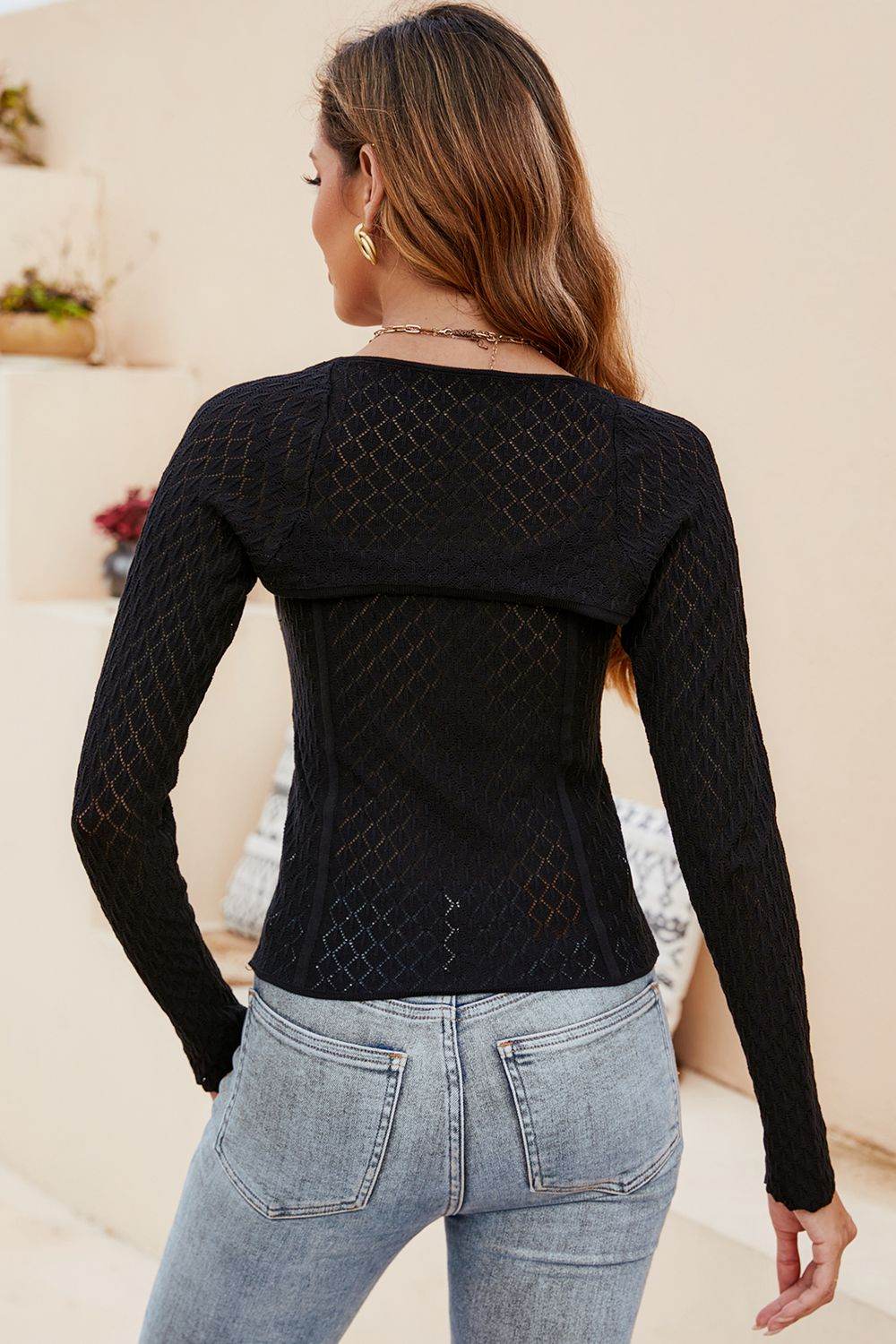 Trendsi Long Sleeve Knit Top in black with a stylish back design for a trendy look