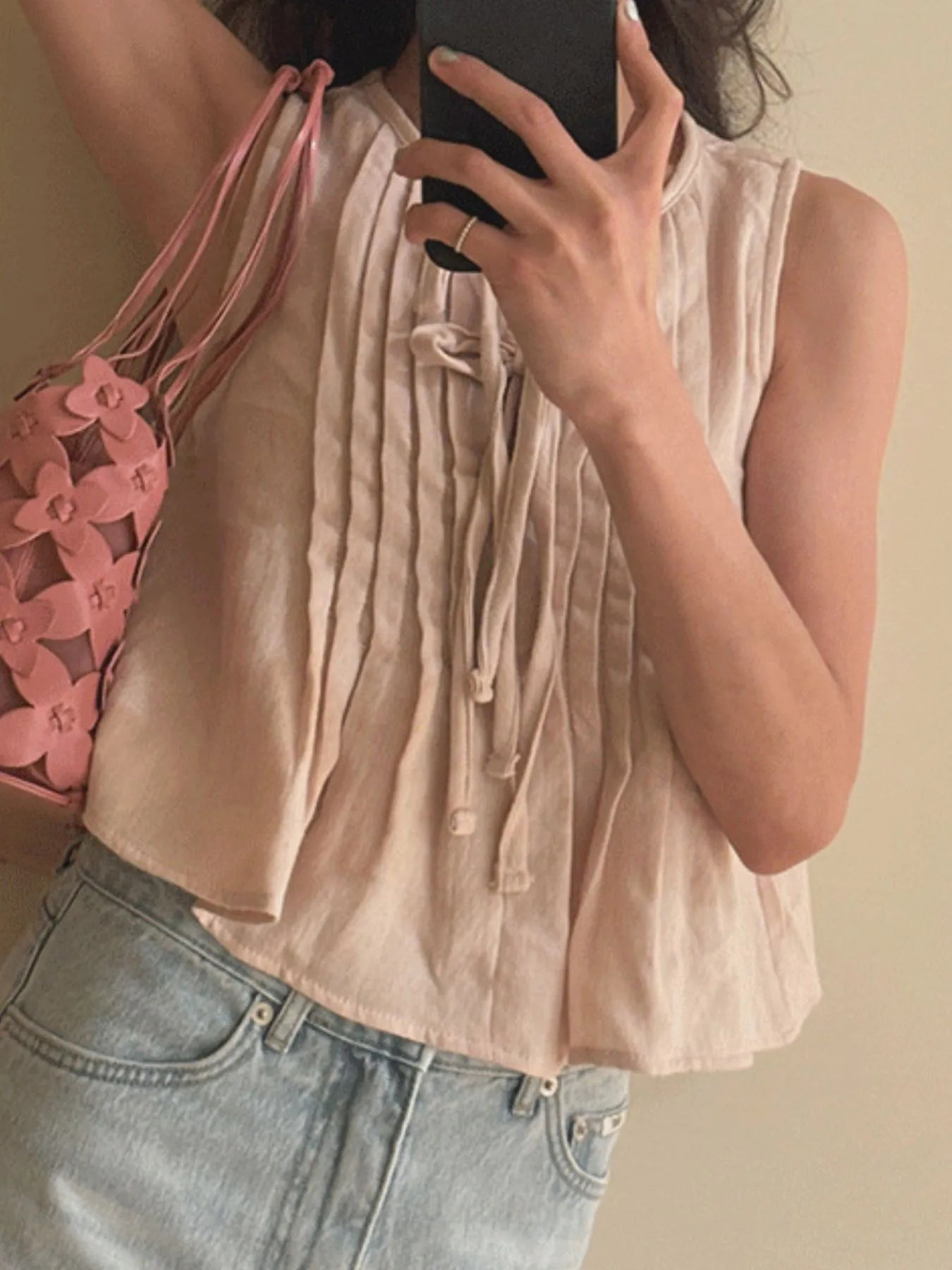 Trendsi Sleeveless Summer Blouse beige pintuck front with tie detail shown worn with light wash jeans and pink bag