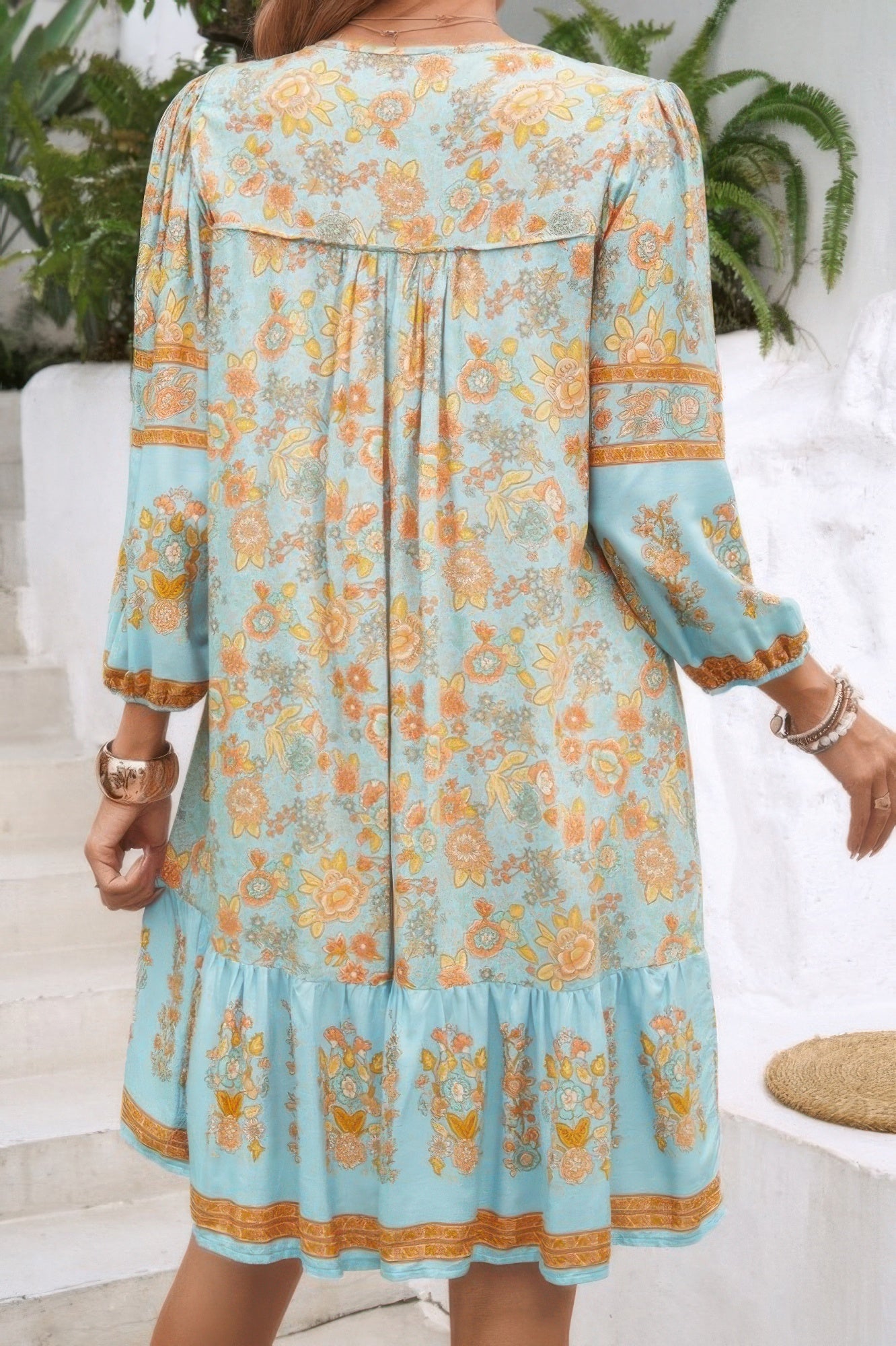 CCWHOLESALECLOTHING boho tassel v neck dress aqua floral print with three quarter sleeves tiered hem back view