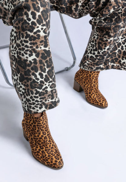 Lunara Leopard Print ankle boots in brown and black paired with matching leopard print pants