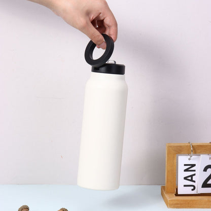Fashions Envy white stainless water bottle with black lid held by hand and Magnetic Phone Holder ring