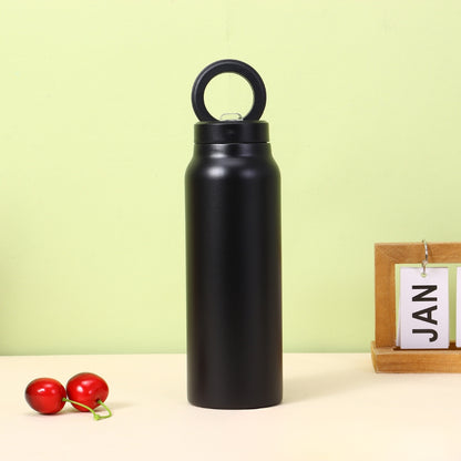 Fashions Envy black stainless water bottle with loop cap on table with cherries and JAN block Magnetic Phone Holder