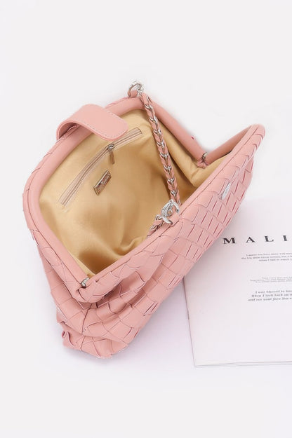 Pink faux leather braided shoulder bag with silver chain strap and beige interior pocket open top view