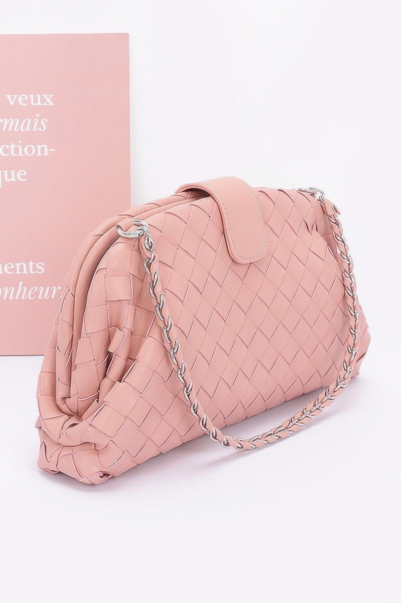 Blush pink faux leather braided shoulder bag with silver chain strap and top flap closure