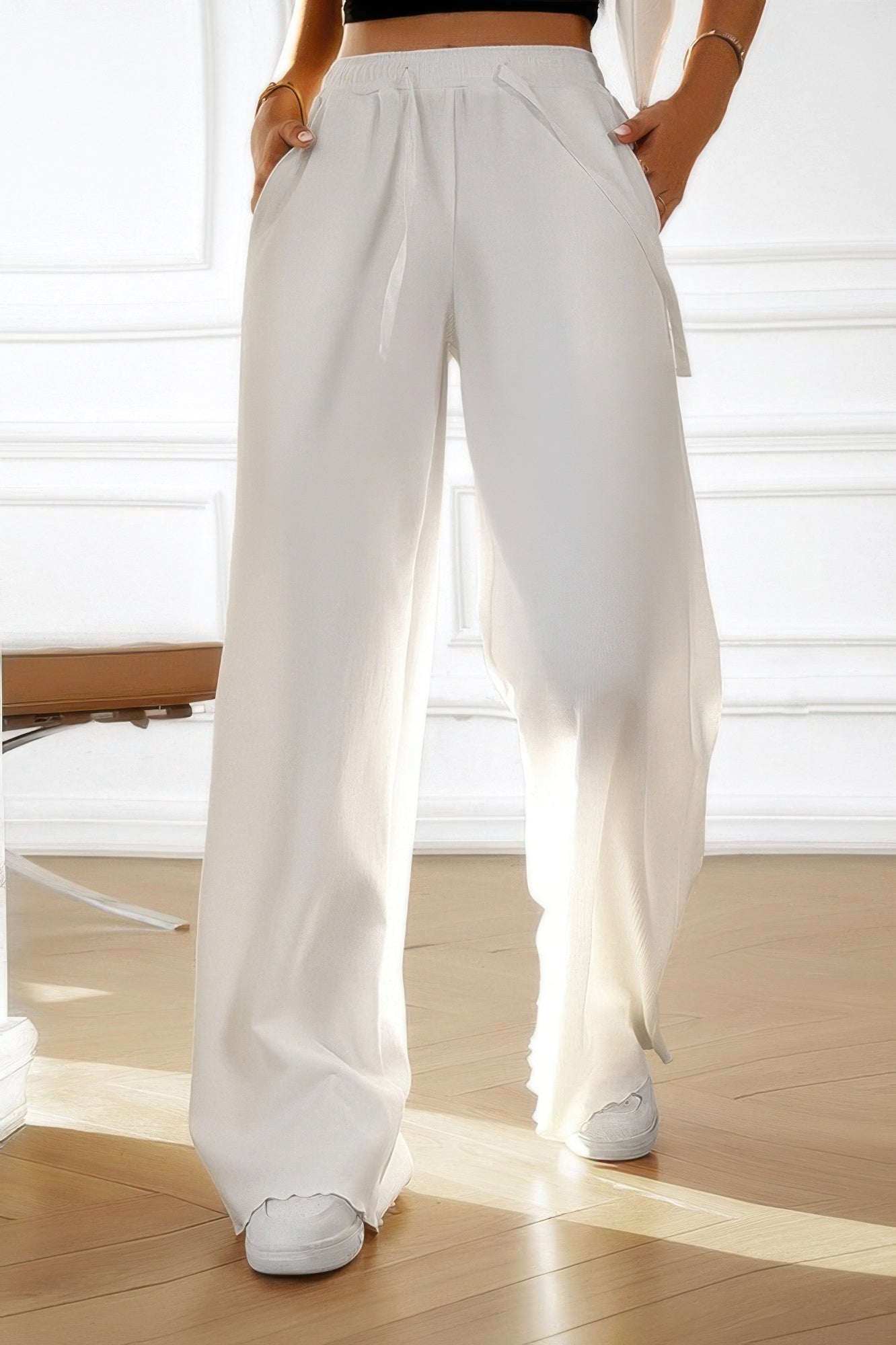 White high rise women's elastic waist straight pants with drawstring and side pockets worn with white sneakers