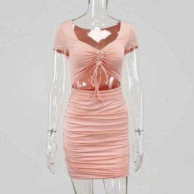 Light pink CJ mini dress with ruched detailing and a cinched front for a stylish look
