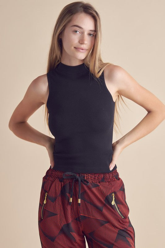 Yelete Mock Neck Tank in Black, perfect for layering or casual wear with stylish red patterned pants