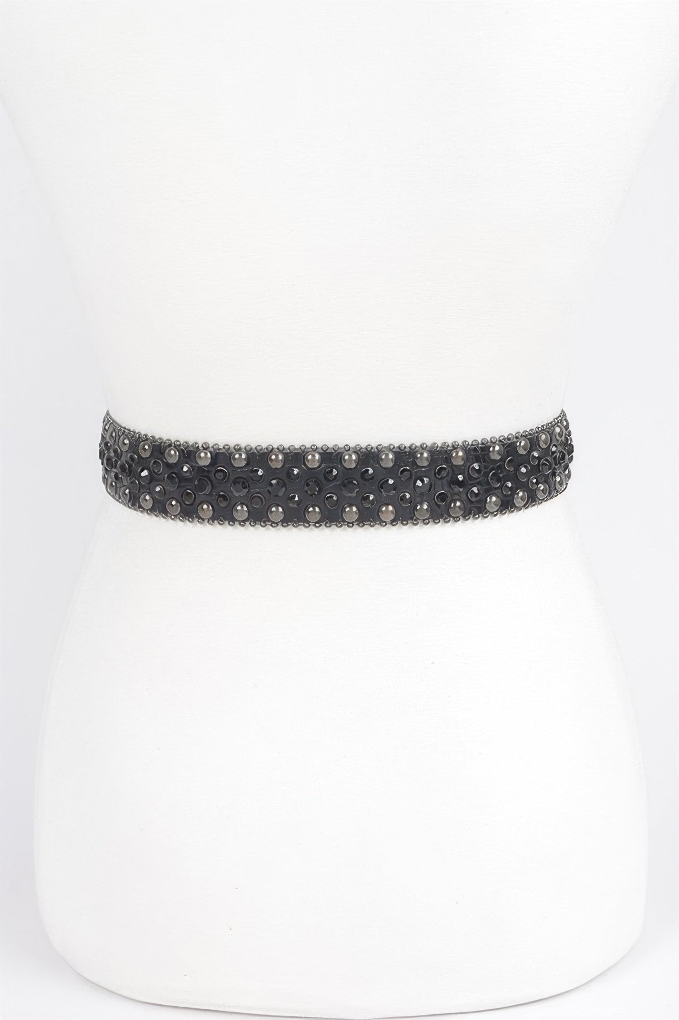 Black rhinestone studded metal belt with gunmetal studs and woven design displayed on white mannequin