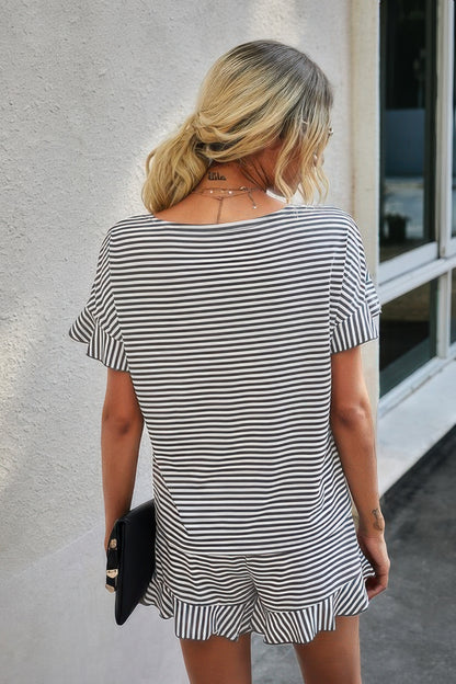 Back view of woman wearing striped short set for women black and white ruffle sleeve top and shorts