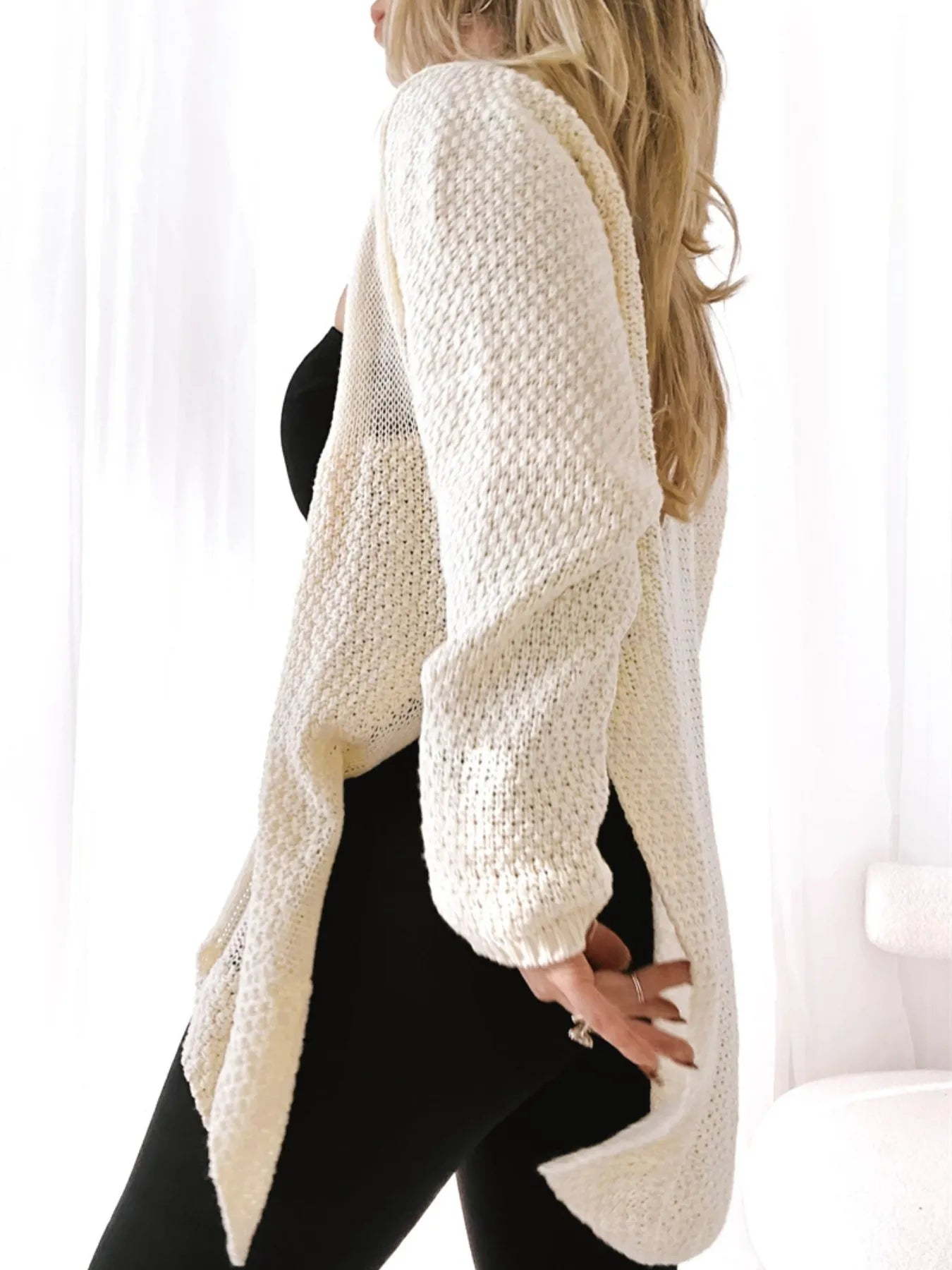 Trendsi model wearing cream textured Oversized Knit Cardigan over black outfit with open front and long drape
