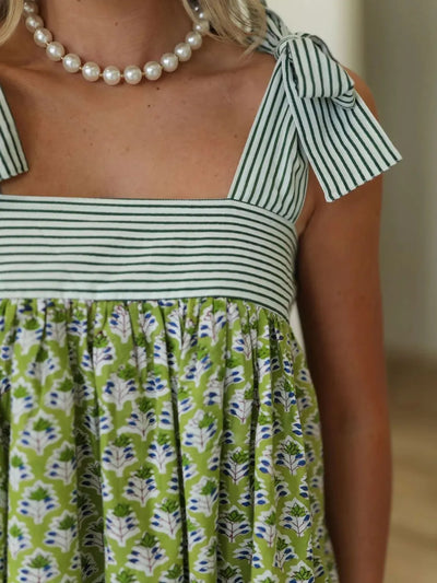 Trendsi Tie Shoulder Mini Dress green floral print with striped bodice tie shoulder straps and pearl necklace