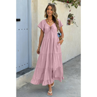 Model wearing dusty pink square neck ruffle hem dress styled with v tie neckline tiered skirt and flutter sleeves