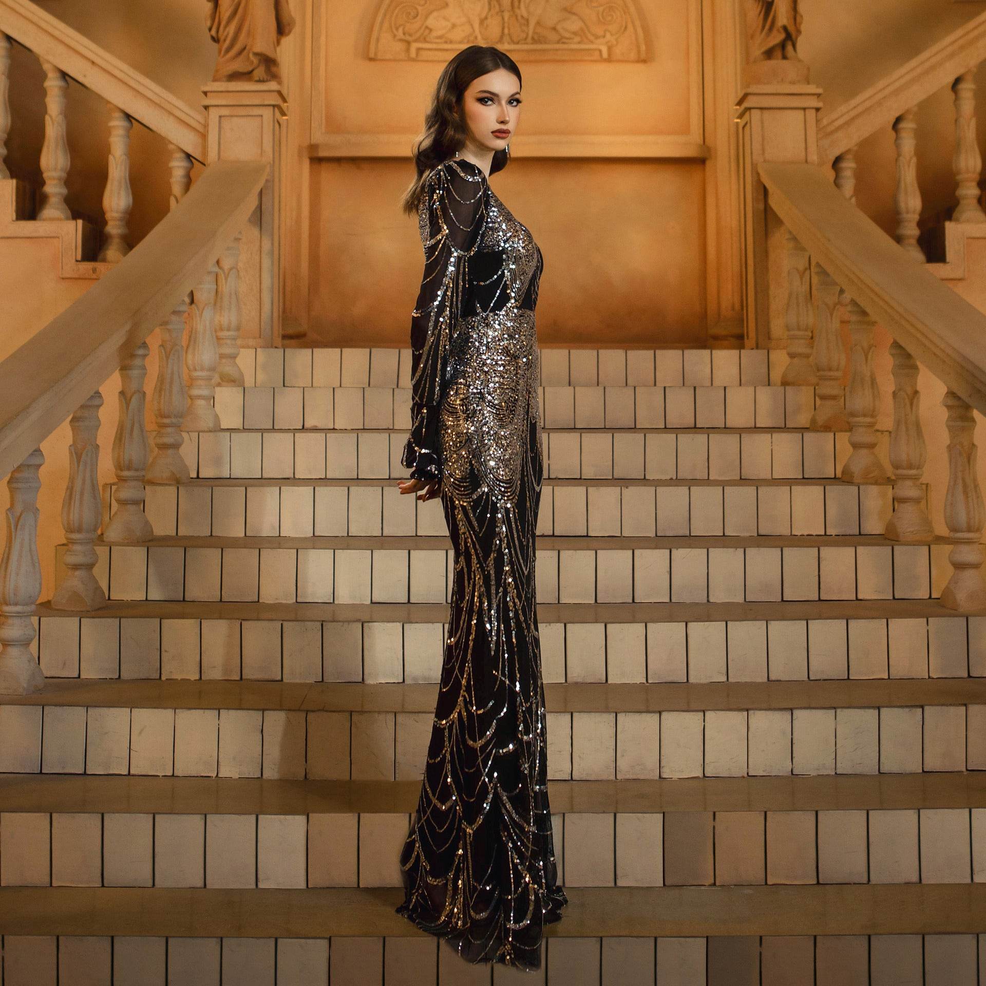 Elegant model wearing a Sequined Fishtail Wedding Dress in black with long sleeves and stunning details
