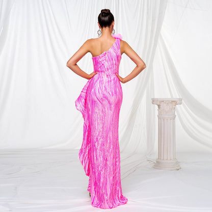 Back view of a pink sequined slit wedding dress featuring a one-shoulder design and flowing skirt