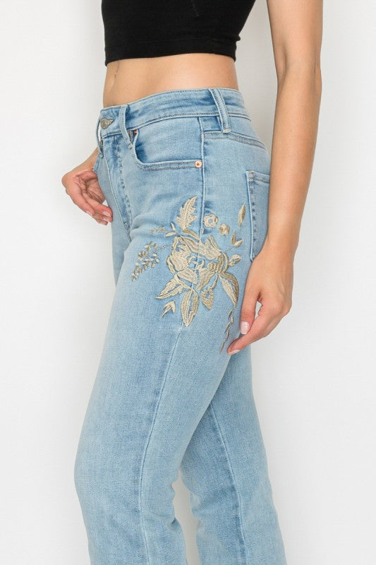 Artemis Vintage model wearing women's high rise embroidered bootcut jeans light wash floral side view