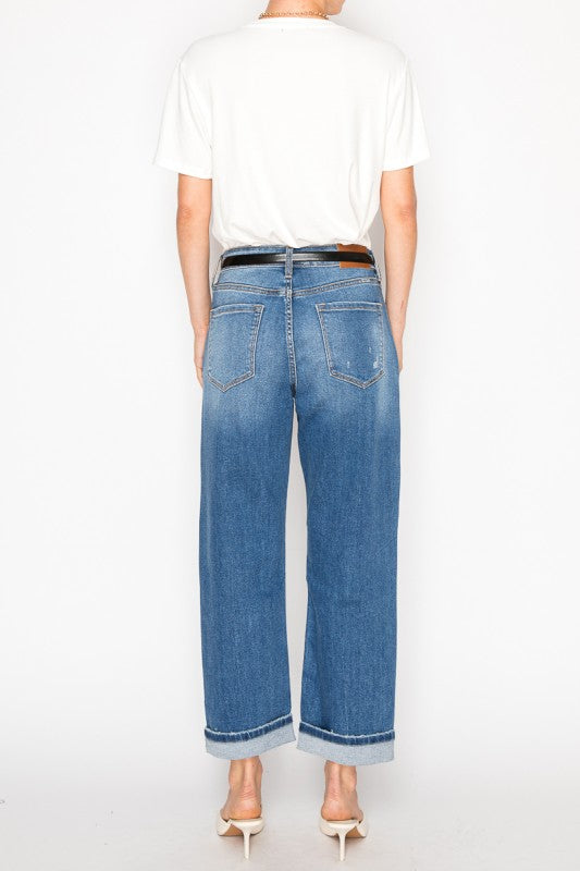 Back view of model in Artemis Vintage women's hybrid high rise jeans cuffed wide leg with black belt