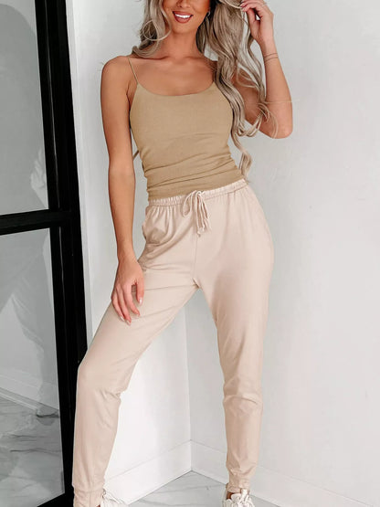 Trendsi Spaghetti Strap Tank Top in Tan, paired with light beige joggers for a stylish casual look