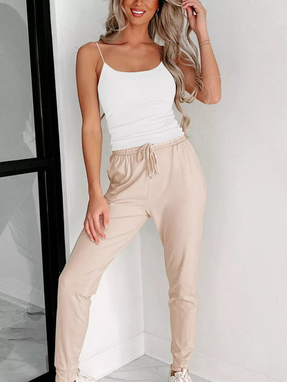 Trendsi Spaghetti Strap Tank Top in white paired with comfortable beige jogger pants