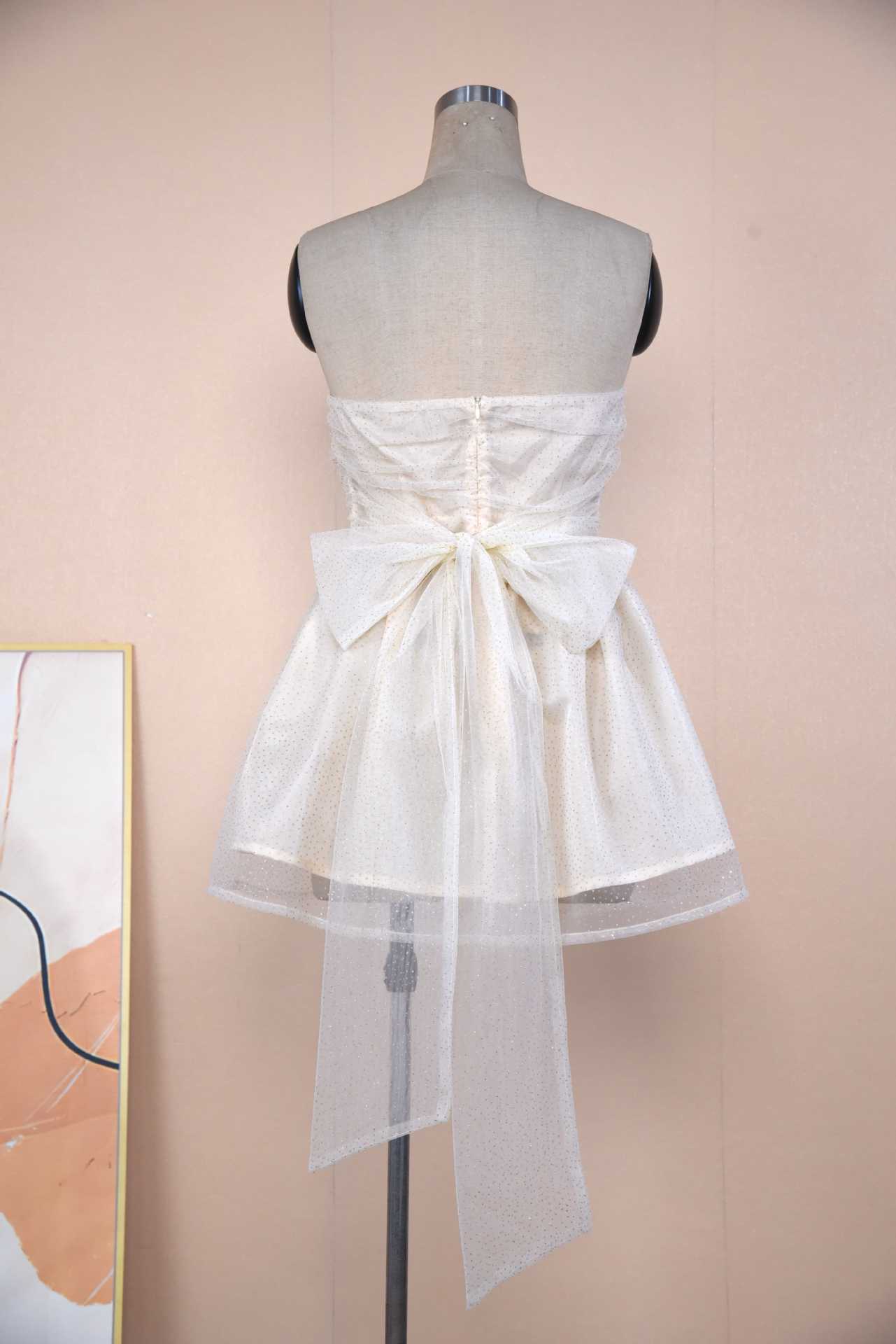 Back view of a Sparkle Strapless Mini Dress featuring a bow detail and delicate fabric